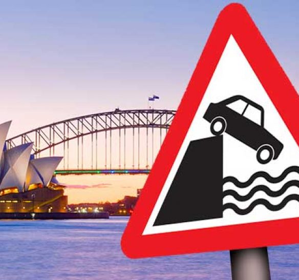Sydney harbour with a water's edge warning sign