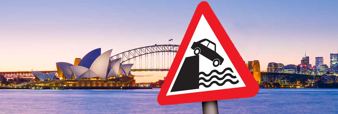 Sydney harbour with a water's edge warning sign