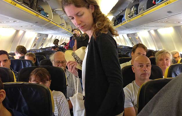 A passenger making her way to her seat during the boarding of a Ryanair flight at Jerez Airport in Spain