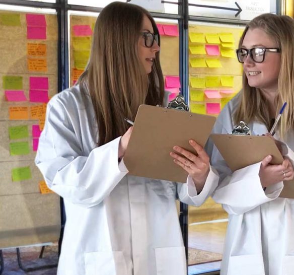 Customer experience mapping workshop with two women dressed as scientists