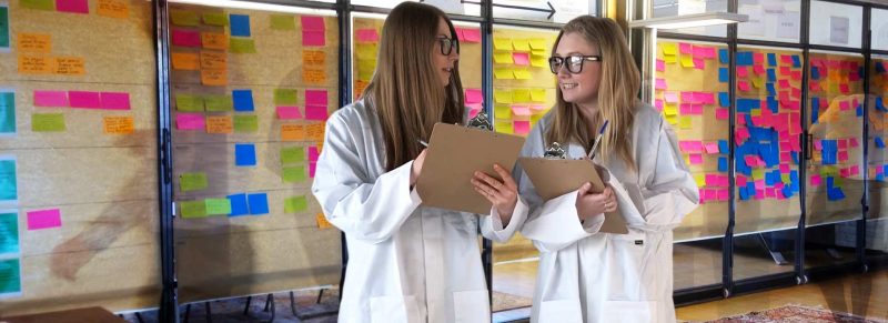 Customer experience mapping workshop with two women dressed as scientists